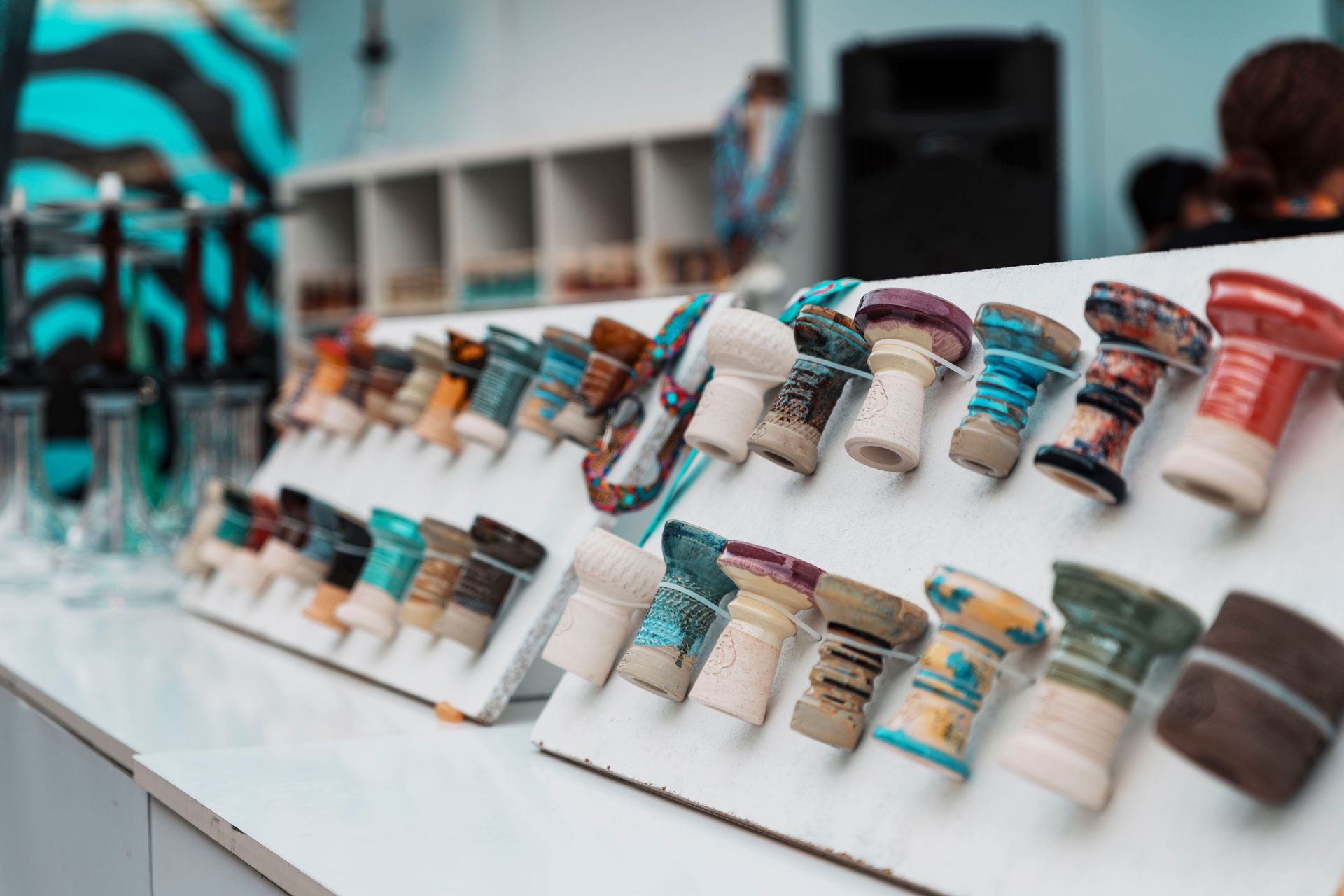 Vibrant ceramic hookah bowls on display in a modern shop setting, ideal for lifestyle imagery.