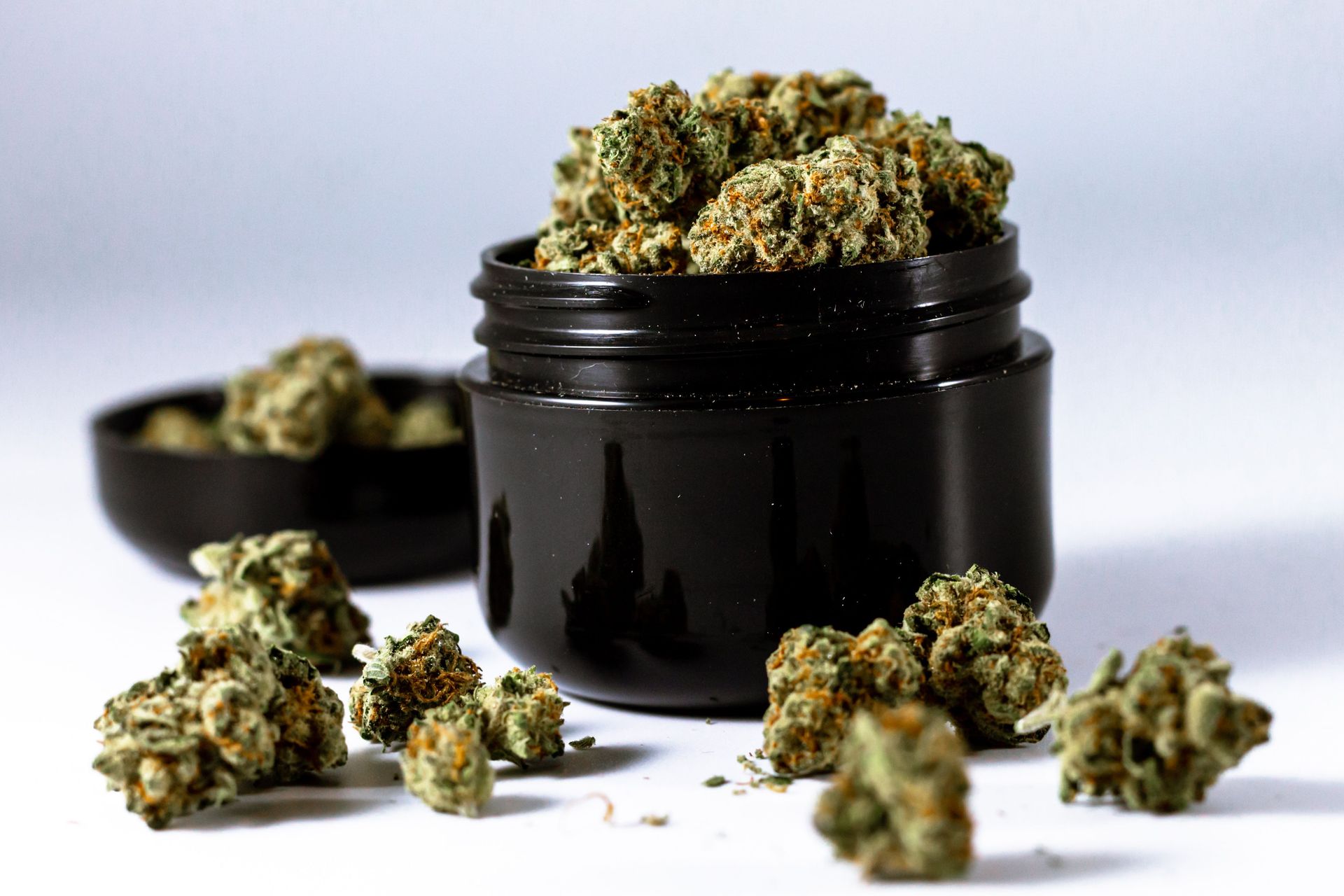 High-resolution image of cannabis buds in a black container, suitable for medical and recreational use.